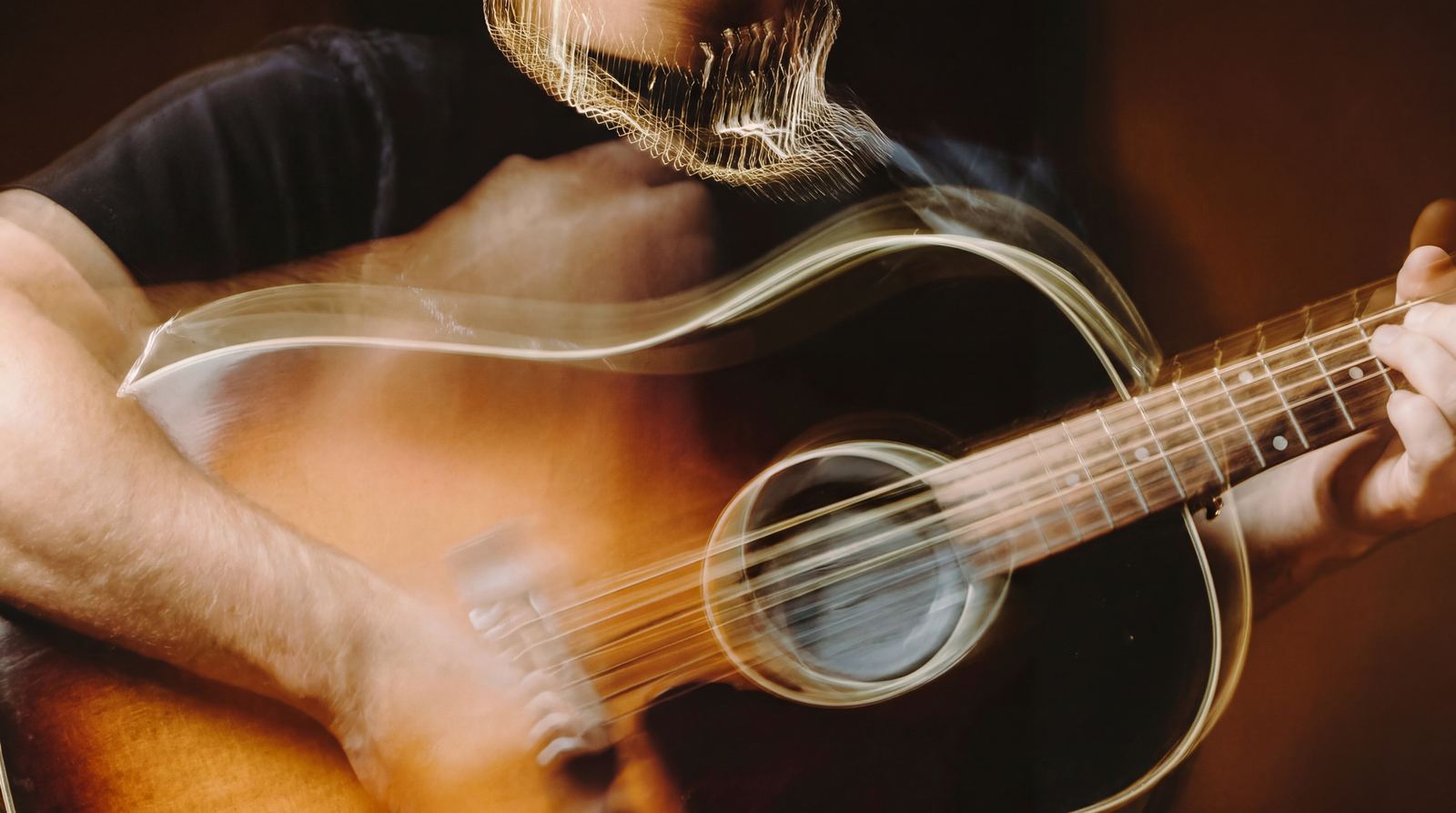 Guitarist mid-song, hands in motion